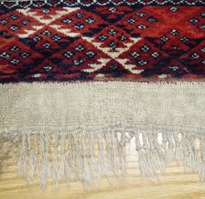 Fringe replacement: new fringe is created by stitching threads into linen fabric. The fabric is then attached onto rug.